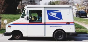 A USPS truck delivering mail